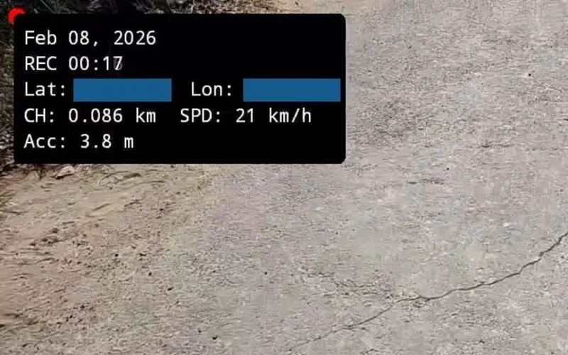 Crop of a frame recorded by the Chainage app: the burnt-in panel showing time, chainage, speed and GPS accuracy over a cracked concrete surface.